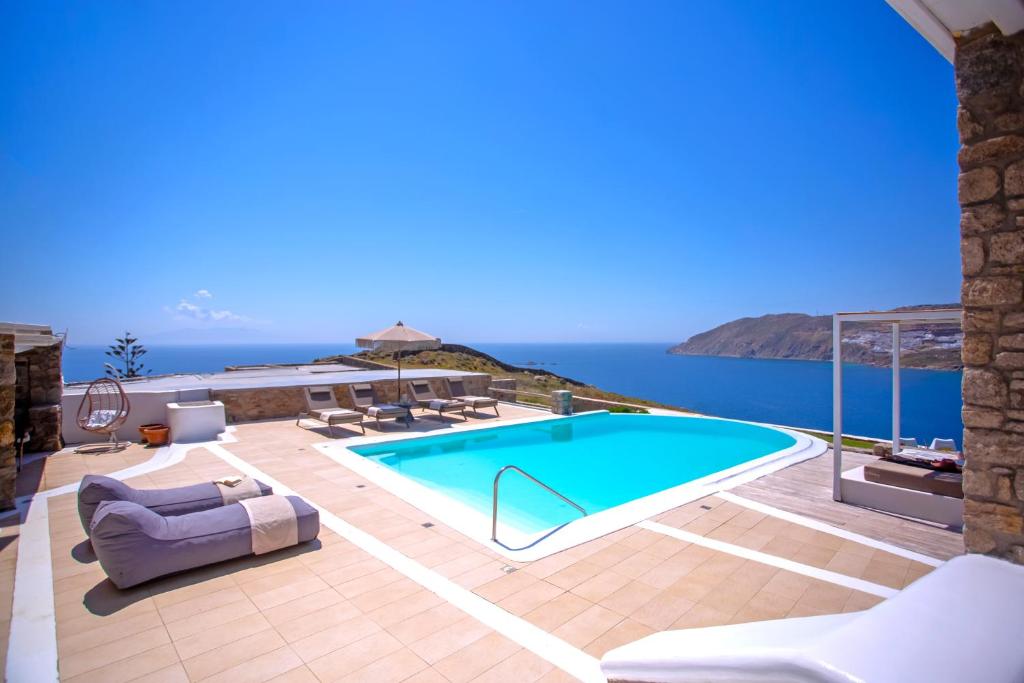 a swimming pool with a view of the ocean at South Star private Villa in Mikonos