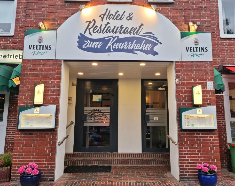 a brick building with a sign for a restaurant at Hotel Knurrhahn DZ in Wilhelmshaven