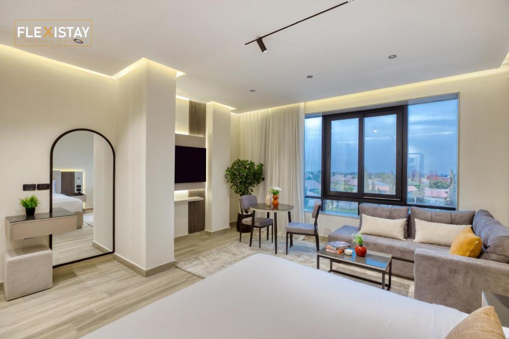 a living room with a couch and a table at Flexistay Sheikh Zayed in Sheikh Zayed