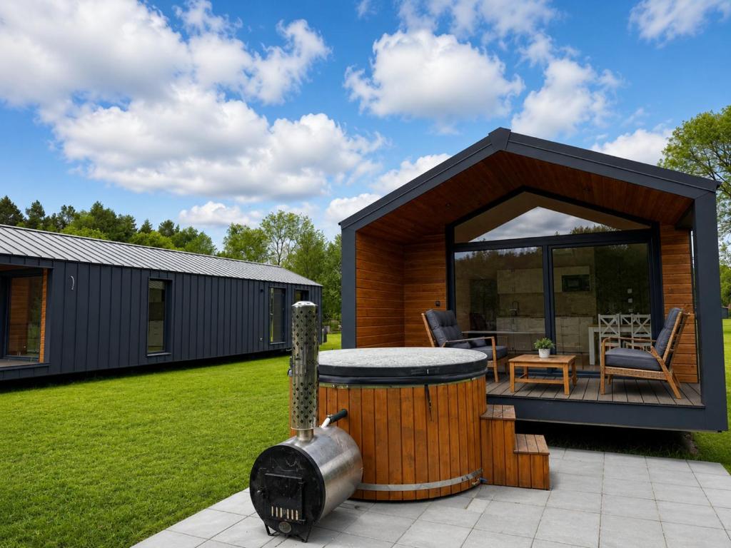 a small house with a gazebo in a yard at Łeba Luxury House in Łeba