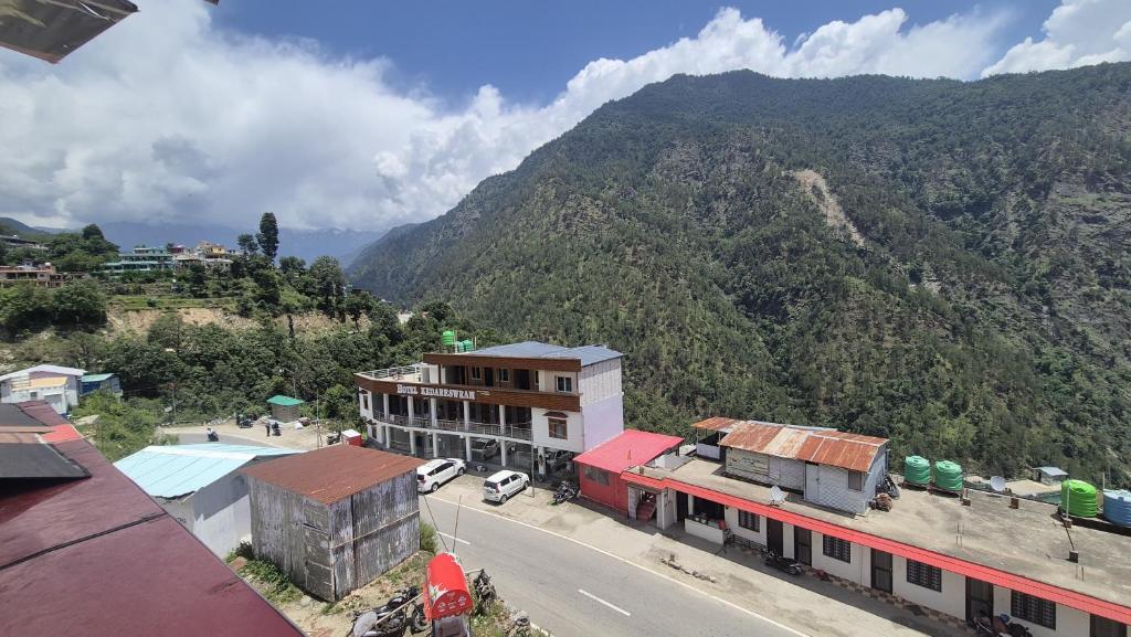 a view of a city with a mountain in the background at Hotel astha in Phata