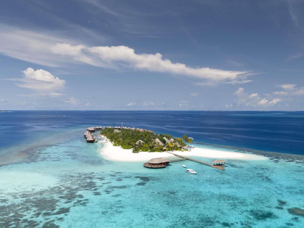 an island in the ocean with boats in the water at V Villas Maldives at Mirihi - MGallery Collection in Mandhoo