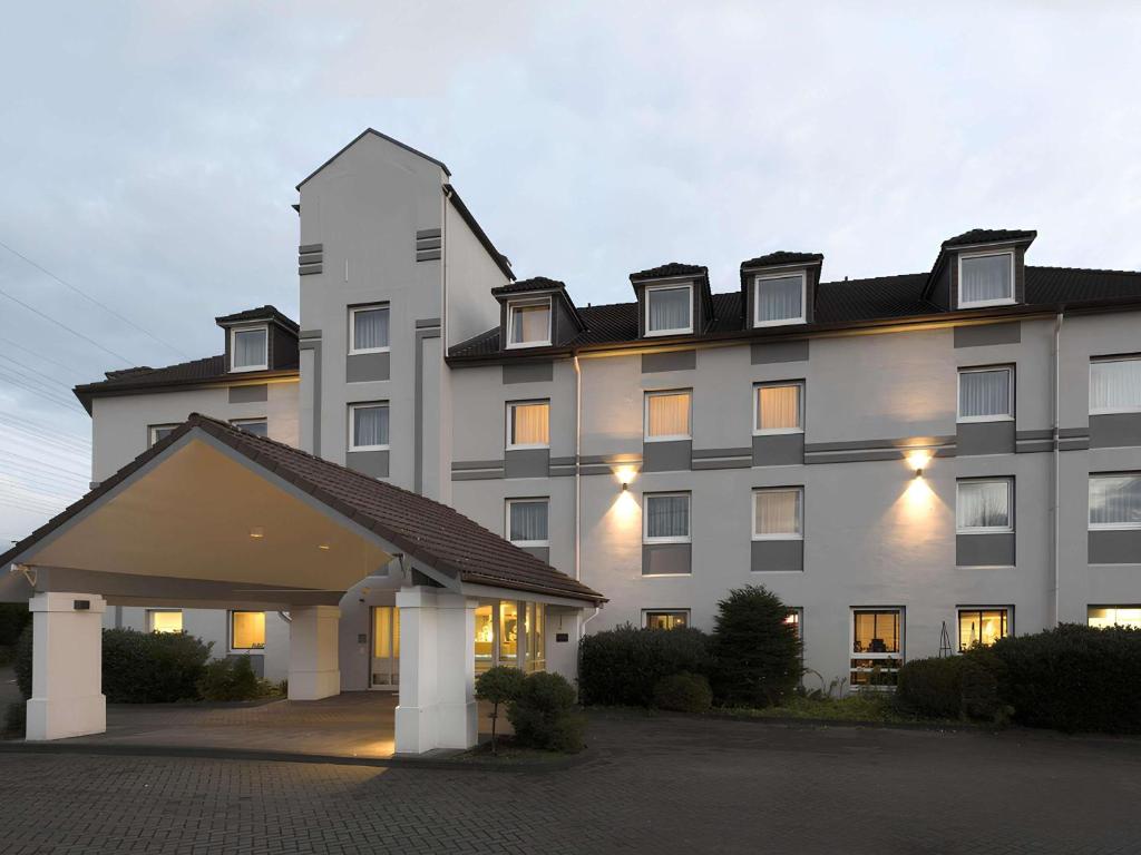 a large white building with a lot of windows at ibis Styles Cologne Airport in Troisdorf