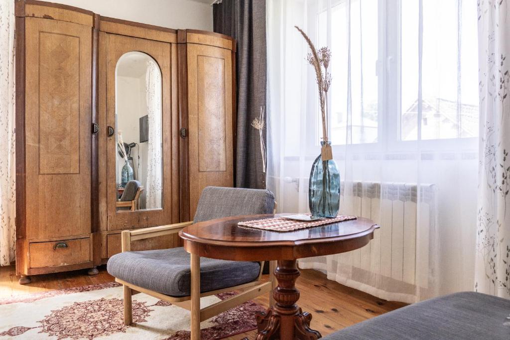 a room with a table and a chair and a mirror at Willa Antonina in Supraśl