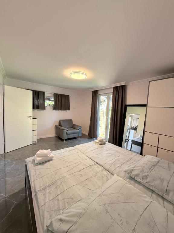 a large bedroom with a large bed and a couch at Ferienwohnung Otterberg in Otterberg