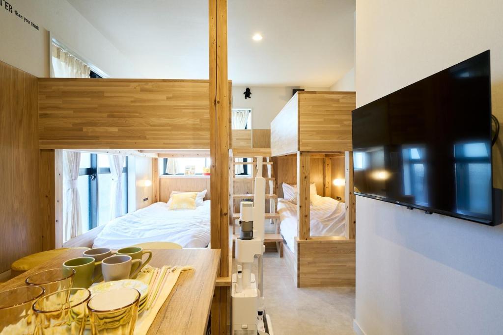 a bedroom with a bunk bed and a dining room with a table at Inside Sangreen - Vacation STAY 22714 in Tokyo