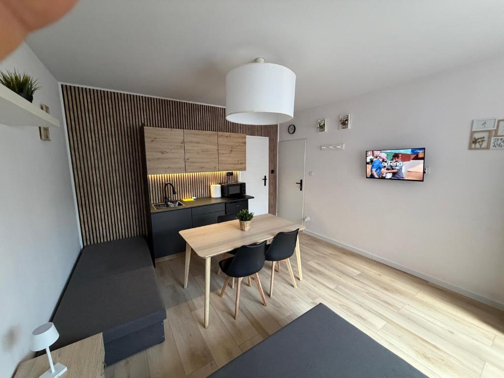 a kitchen and dining room with a table and chairs at Apartament Tczew-duże pokoje! in Tczew
