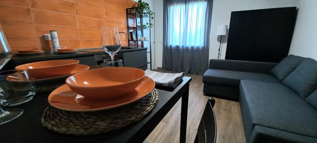 a living room with a table with bowls and a couch at Il Falcineto in Pesaro