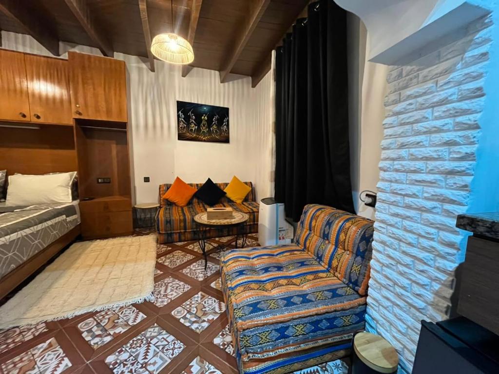 a living room with a couch and a bed at Studio ALADIN in Rabat