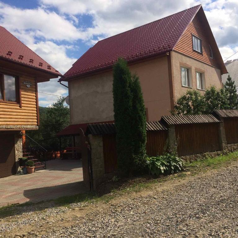 a house with a fence in front of it at Садиба Хатинка у Люби in Yaremche