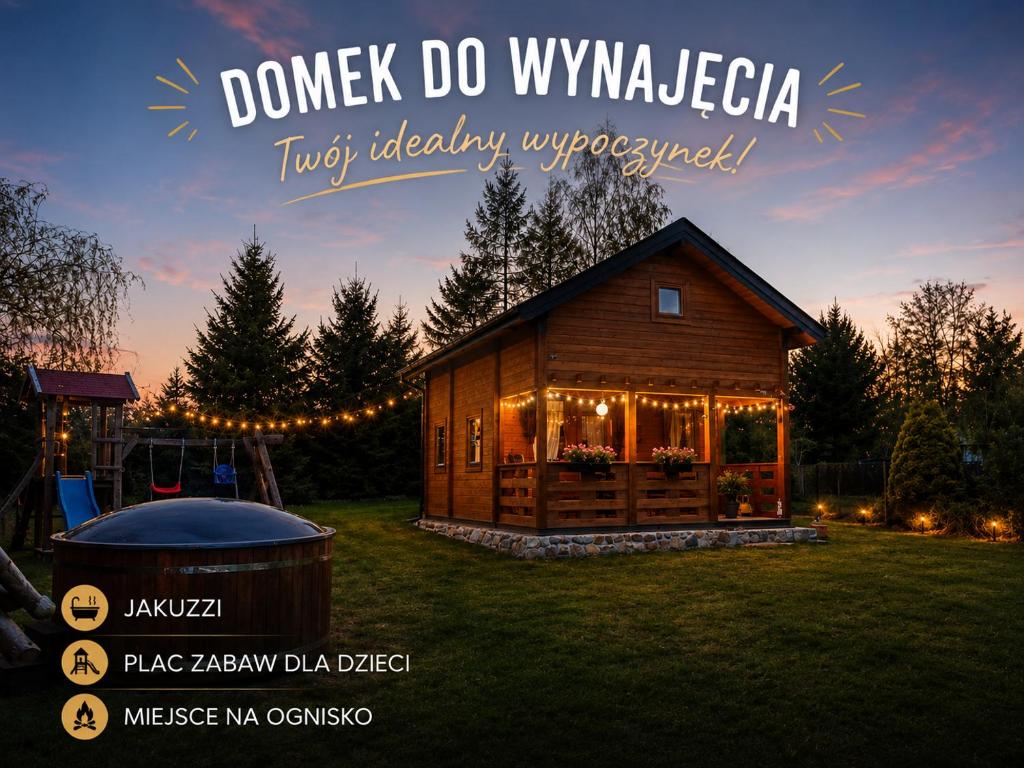 a wooden house with a gazebo in a yard at Domek z BALIA OGRODOWA in Dłużec
