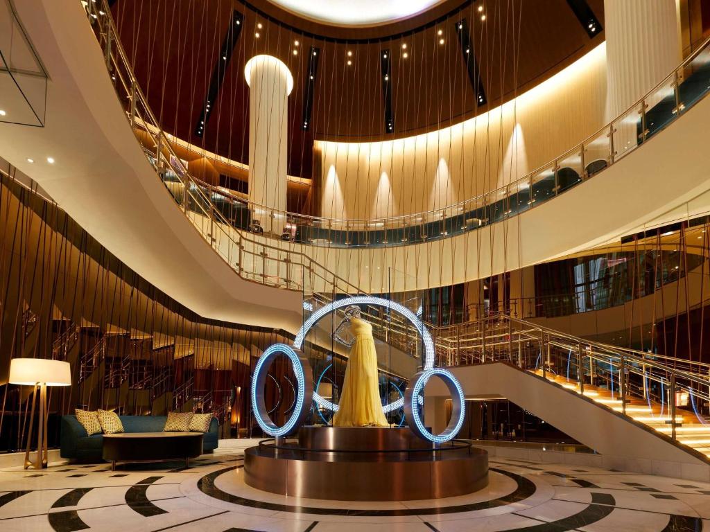 a lobby on a cruise ship with a sculpture in the middle at Hard Rock Hotel New York - Partner of ALL Accor in New York