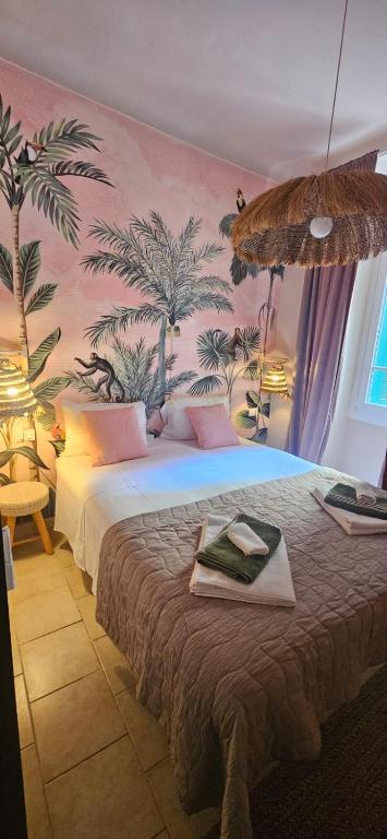a bedroom with two beds with palm trees on the wall at Lola's Sanremo Centro in Sanremo