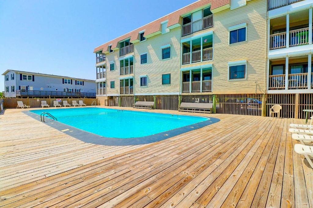 a swimming pool in front of a building at AV2D - By The Sea in Nags Head