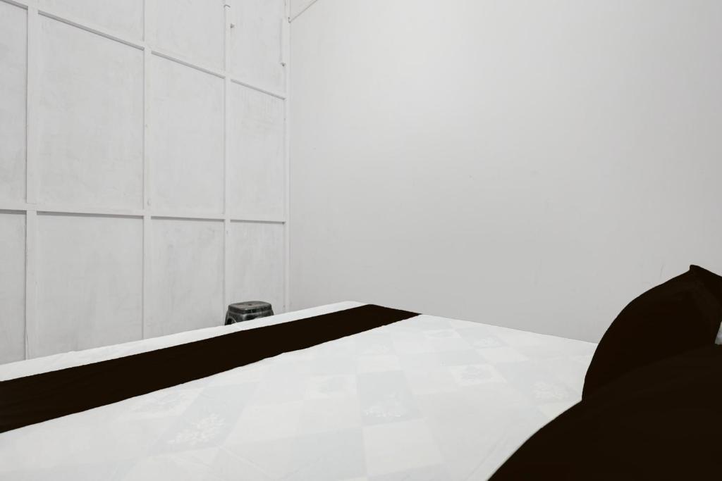 a white tiled bathroom with a white counter top at SPOT ON Milan Hotel in Hāthras