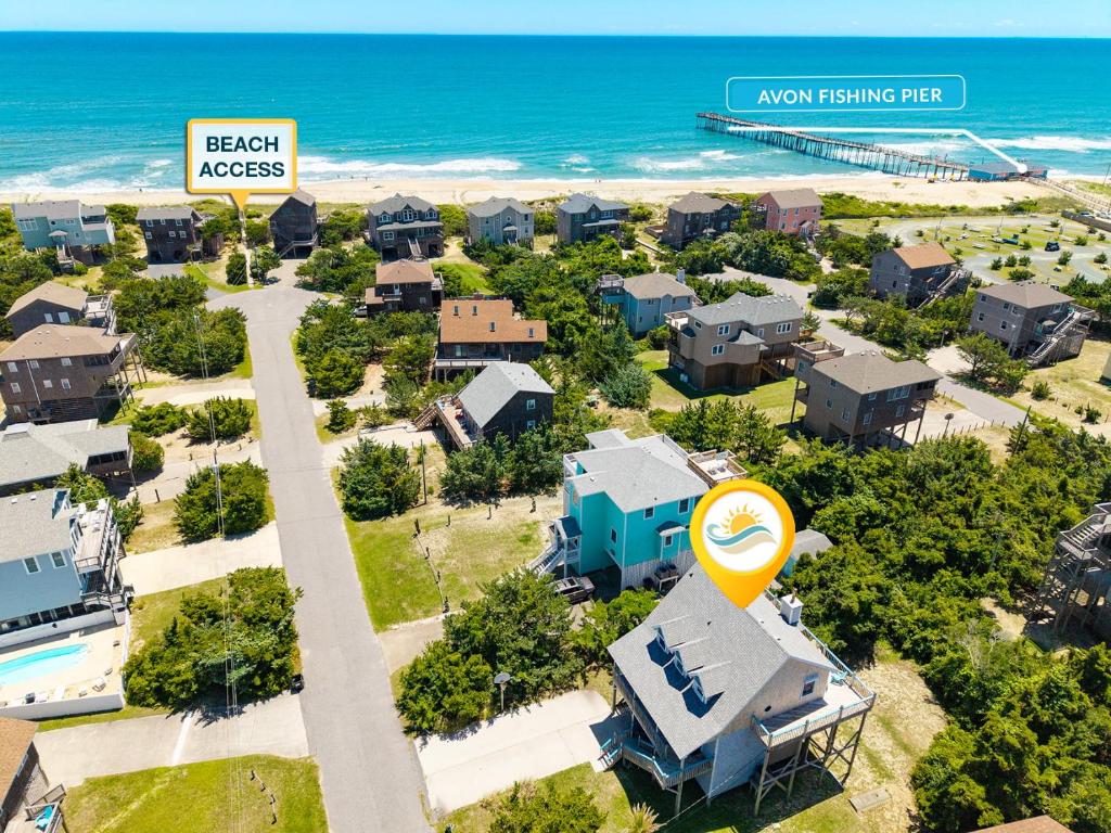 an aerial view of a resort with a beach access sign and the ocean at 8396 - White Dune in Avon