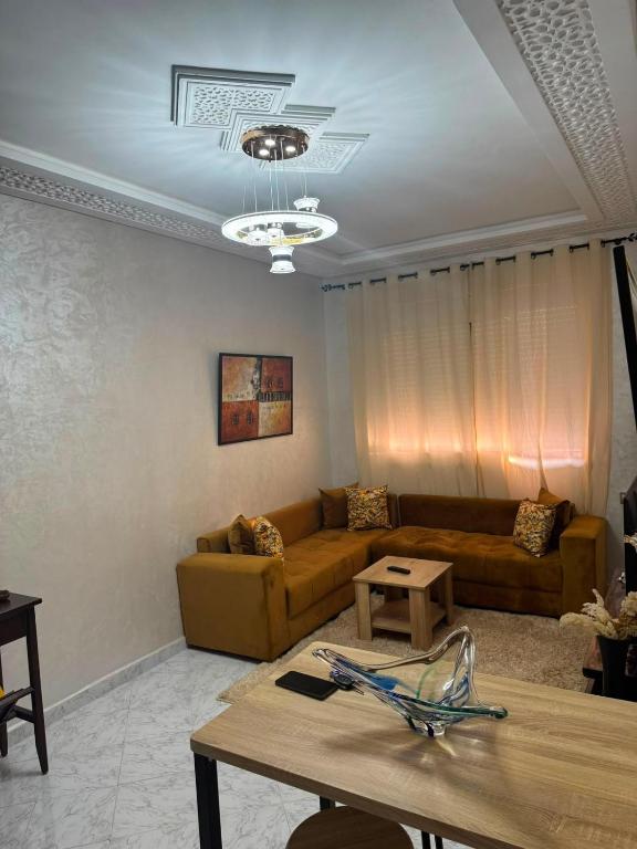 a living room with a couch and a table at Cozy two bedroom apartment in Meknès