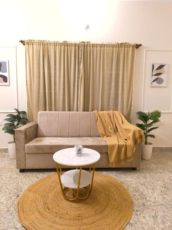 a living room with a couch and a table at Flickstays Hazel in Bangalore