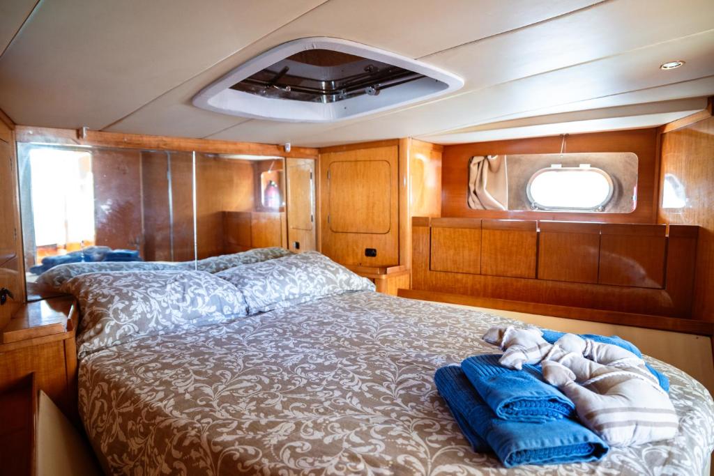 a bedroom with a bed in the middle of a boat at BALI house boat in SantʼAntìoco