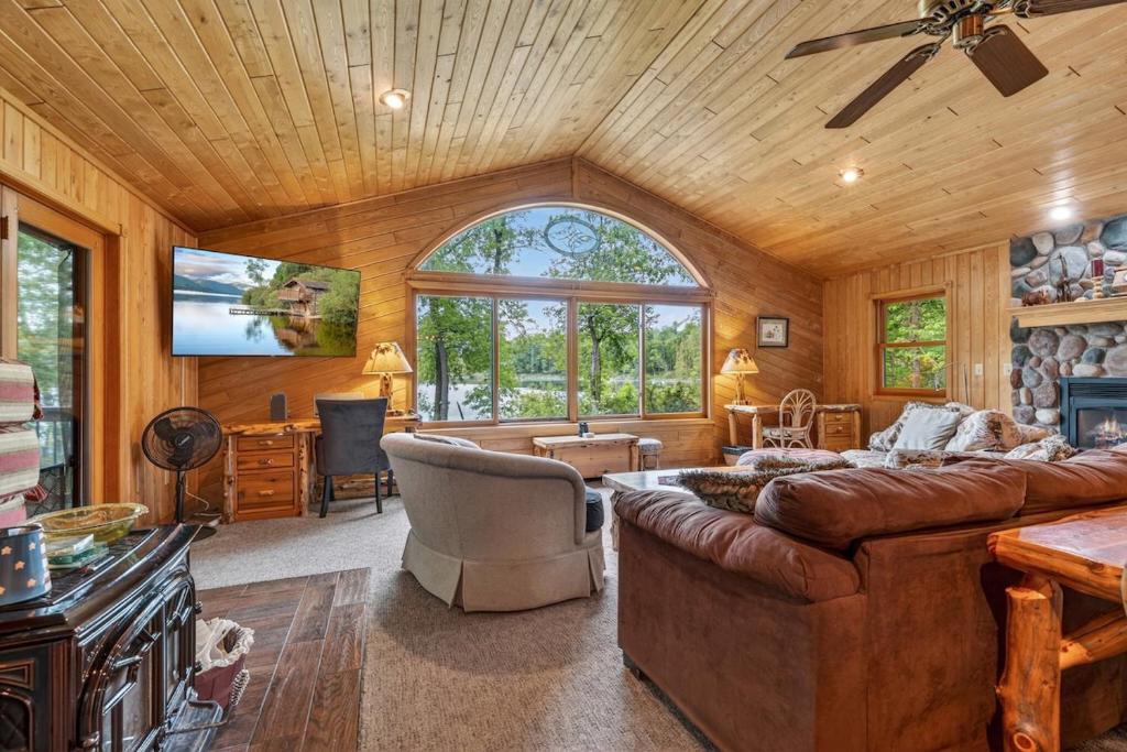 a living room with a couch and a tv at Next Chapter Family Retreat in Pequot Lakes