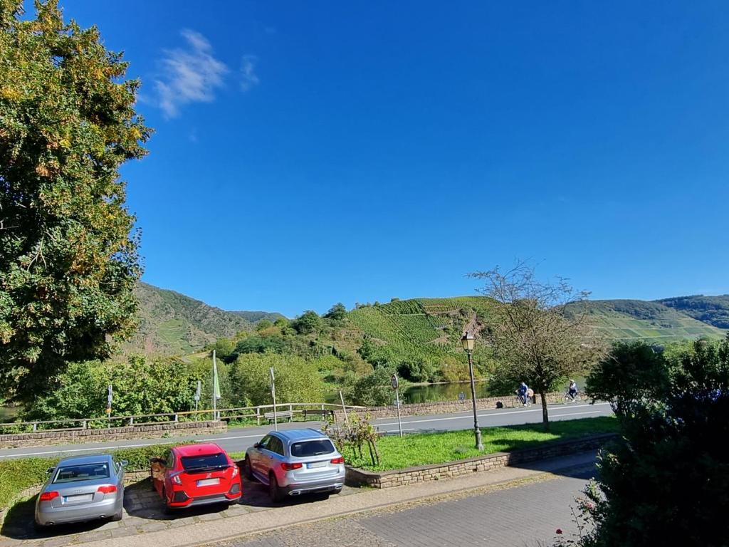 a group of cars parked in a parking lot at Moselidyll im Alten Winzerhaus am Calmont in Bremm