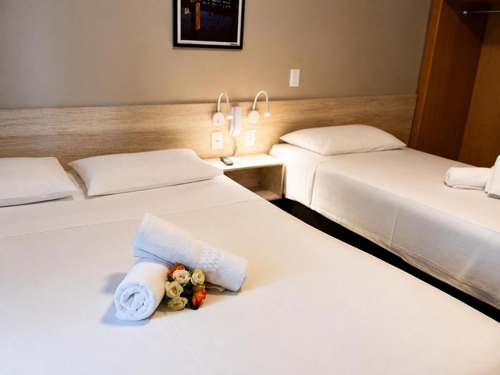 a hotel room with two beds with stuffed animals on them at Hotel Econotel by Bsb Inn in Brasília