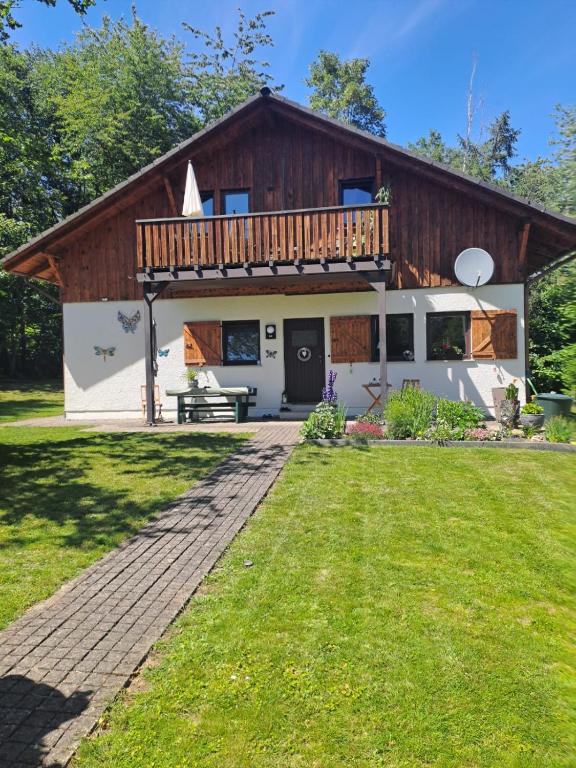 a house with a deck on top of it at Dorfschönheit in Thalfang