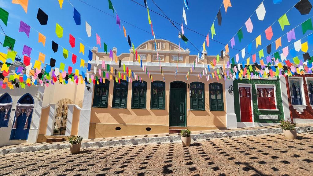 a building with colorful flags in front of it at Pousada Casa de Salim in Lençóis