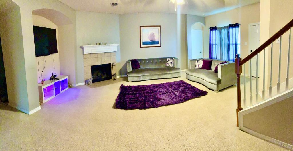 a living room with a couch and a fireplace at Trunks up! Spacious home ready for a fun time! in Lancaster