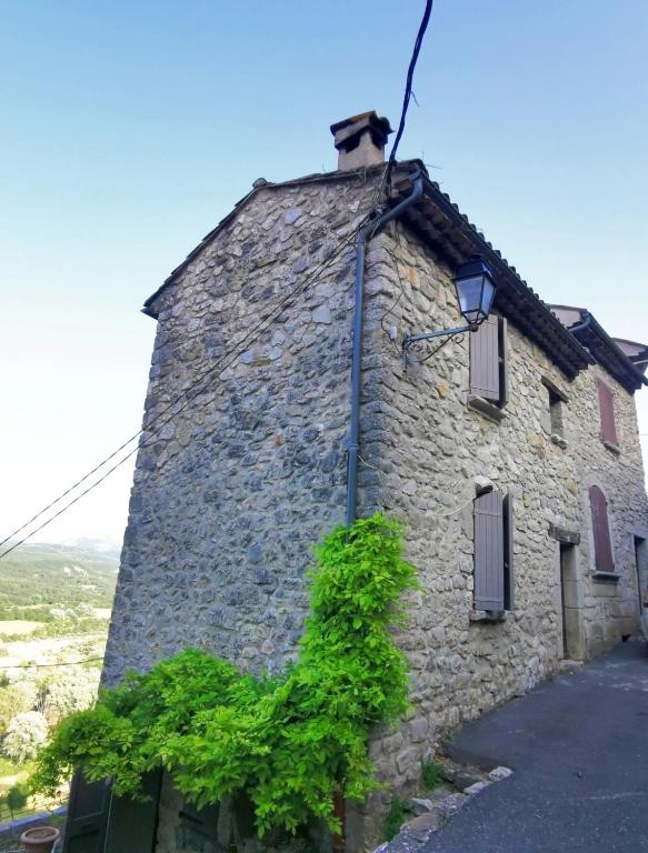 a stone building with a street light on it at Maison de village, Verdon in Trigance