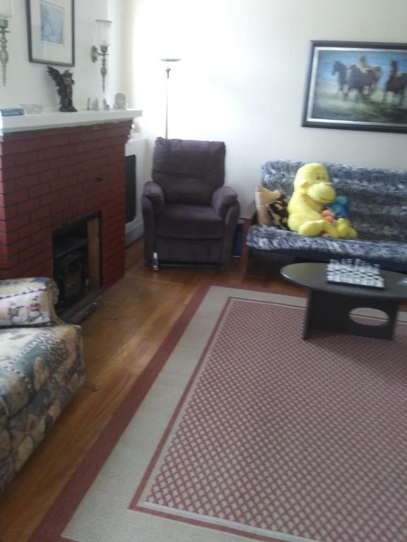 a living room with a couch and a fireplace at Appartement centre ville de Campbellton NB in Campbellton