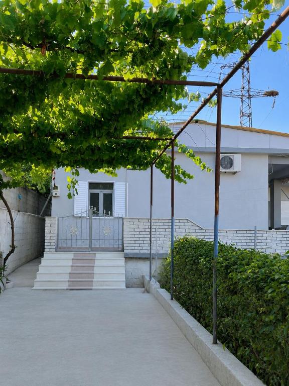 a walkway leading to a white building with stairs at Villa Victoria in Gjirokastër