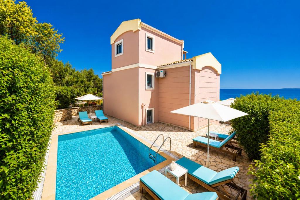 a villa with a swimming pool and a lighthouse at Villa Situla in Barbati
