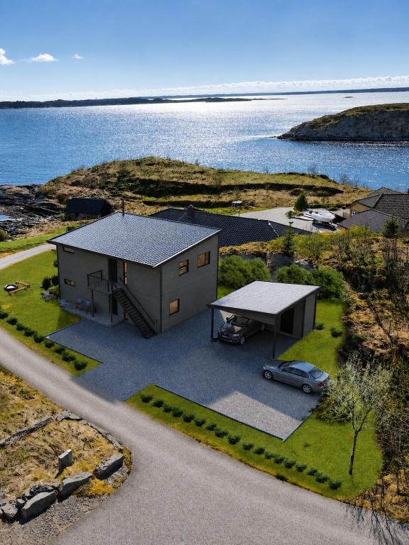 an aerial view of a house next to the water at Fjordhytte-24 in Bøvågen