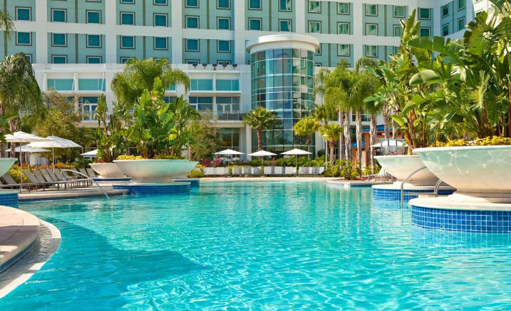 a swimming pool in front of a building at Hilton Orlando in Orlando