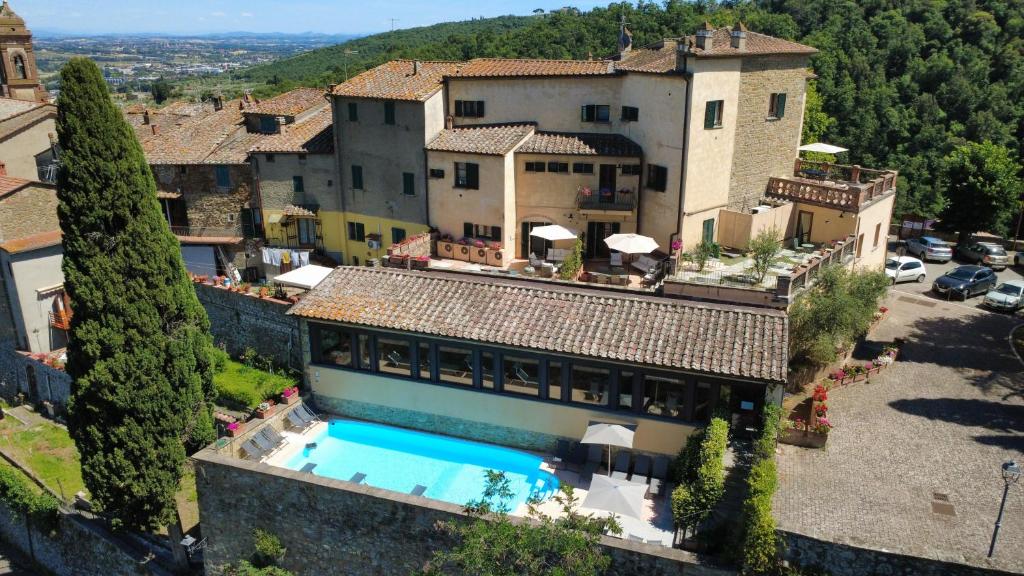 an aerial view of a house with a swimming pool at TUSCANFLAT Castle in Scrofiano