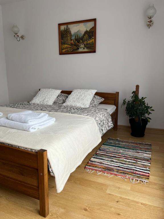 a bedroom with two beds and a rug at Wakacje u Dziadków in Ruciane-Nida