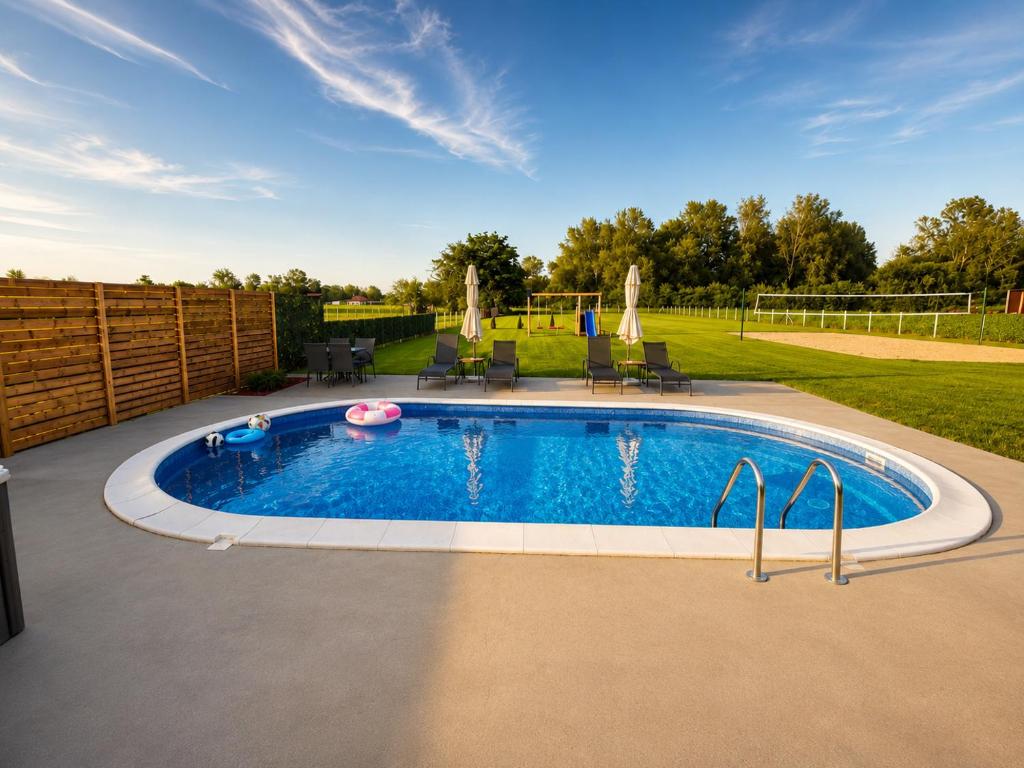 a swimming pool in a yard with a fence at Oaza Gradiška in Bosanska Gradiška