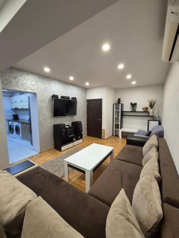 a living room with a couch and a table at Апартамент riverside in Yambol