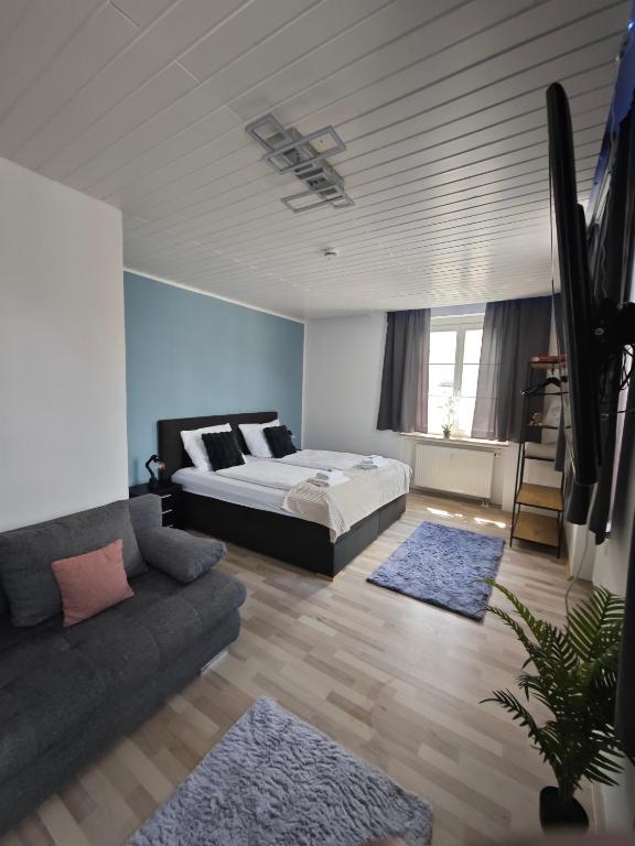 a bedroom with a bed and a couch at Monica Donau in Passau