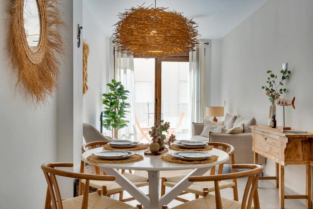 a dining room with a white table and chairs at Bon Dia Moraira in Moraira
