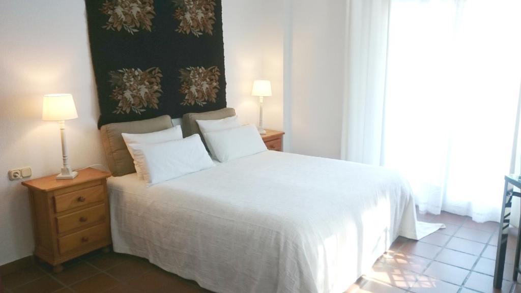 A bed or beds in a room at Apartamentos Turísticos La Mundial