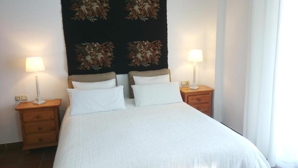 A bed or beds in a room at Apartamentos Turísticos La Mundial