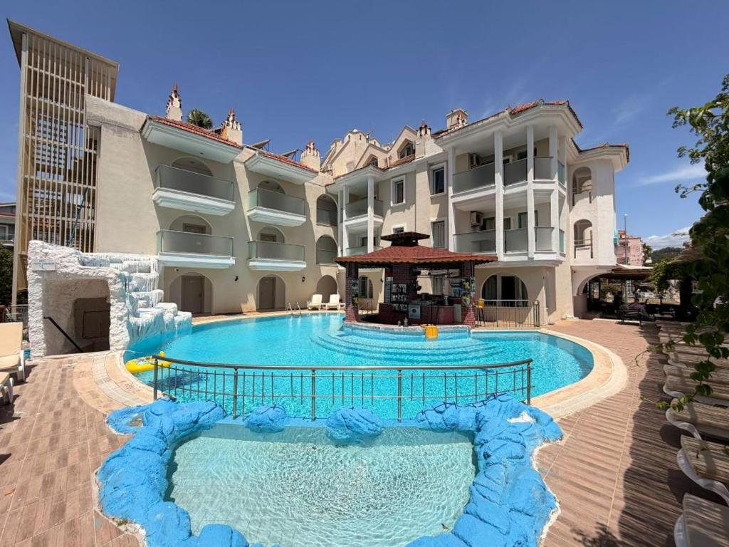 a large swimming pool in front of a building at Rayon Apart hotel in Marmaris