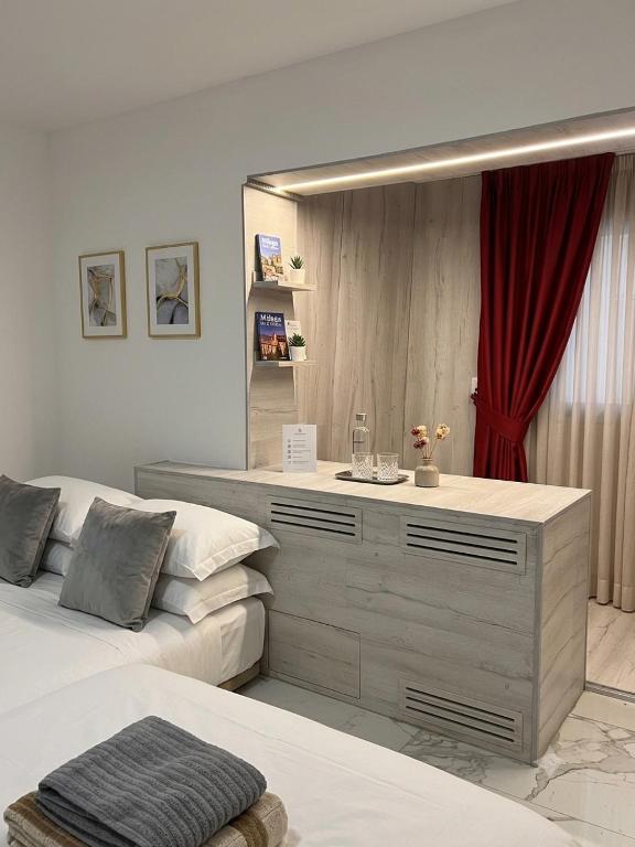 a bedroom with two beds and a dresser with a mirror at Lizz-Hotel in Chişinău