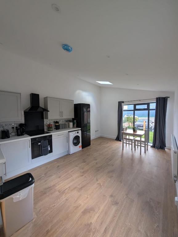a living room with a kitchen and a table at Spacious Bungalow in Beeston in Nottingham