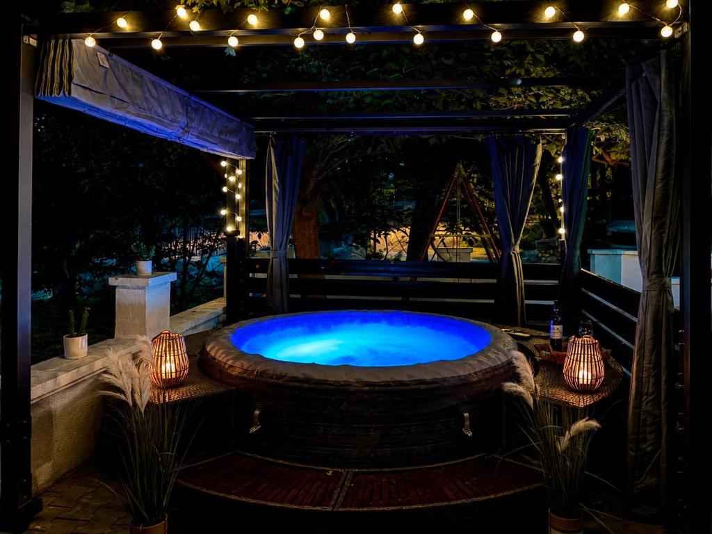 a large hot tub in a patio with lights at Luxury House Cesarica in Cesarica