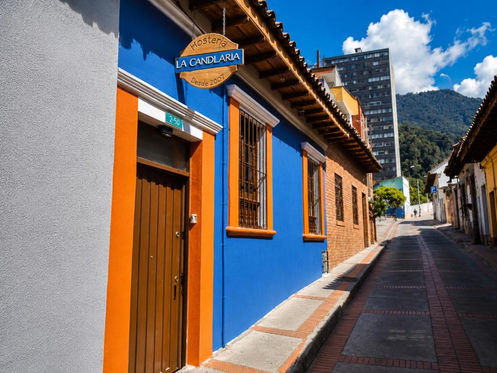 a blue and orange building on the side of a street at Hostal La Candelaria in Bogotá