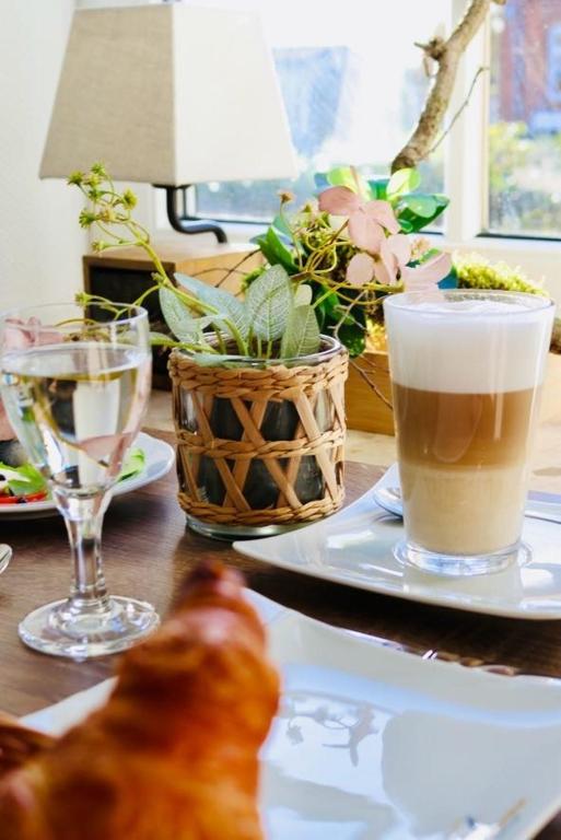 a table with a plate of food and a drink at Hotel zur Seemöwe in Insel Poel