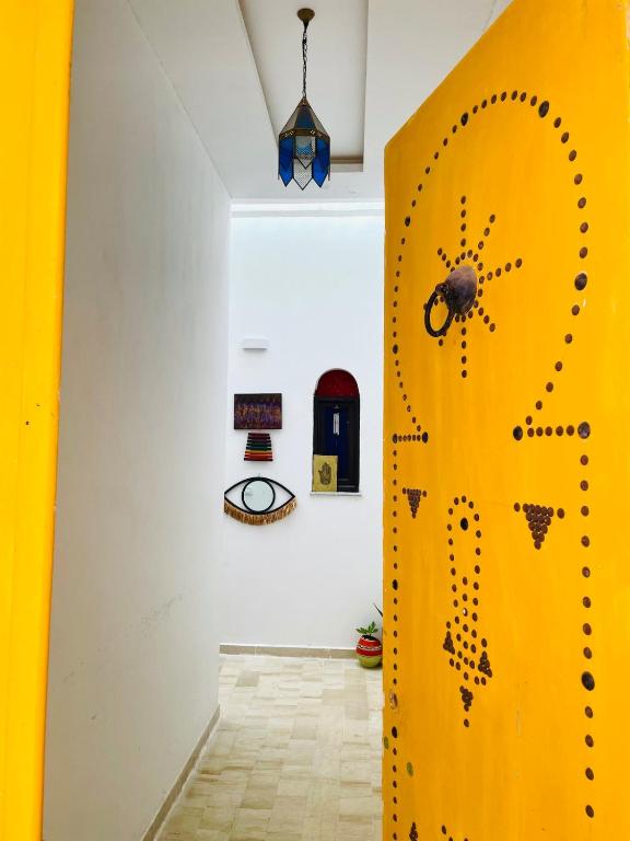 a yellow door in a room with a white wall at Dar D'Art in Tunis